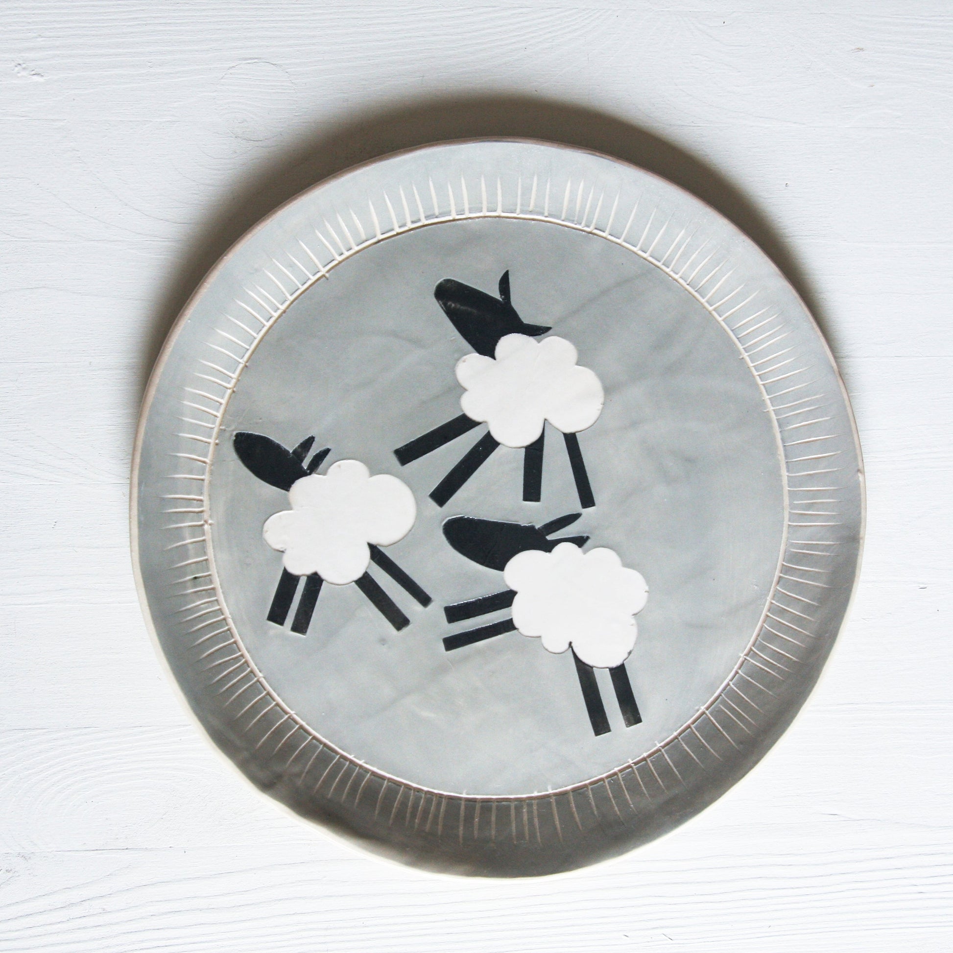 Decorative plate with sheep design on a grey background
